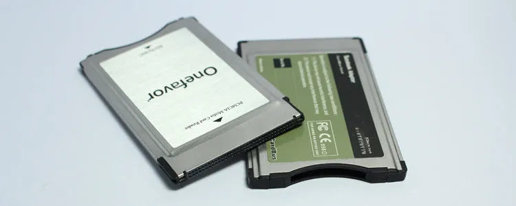 SD to PCMCIA adapter card with stainless steel housing next to a 32GB SDHC card for Mercedes-Benz vehicles