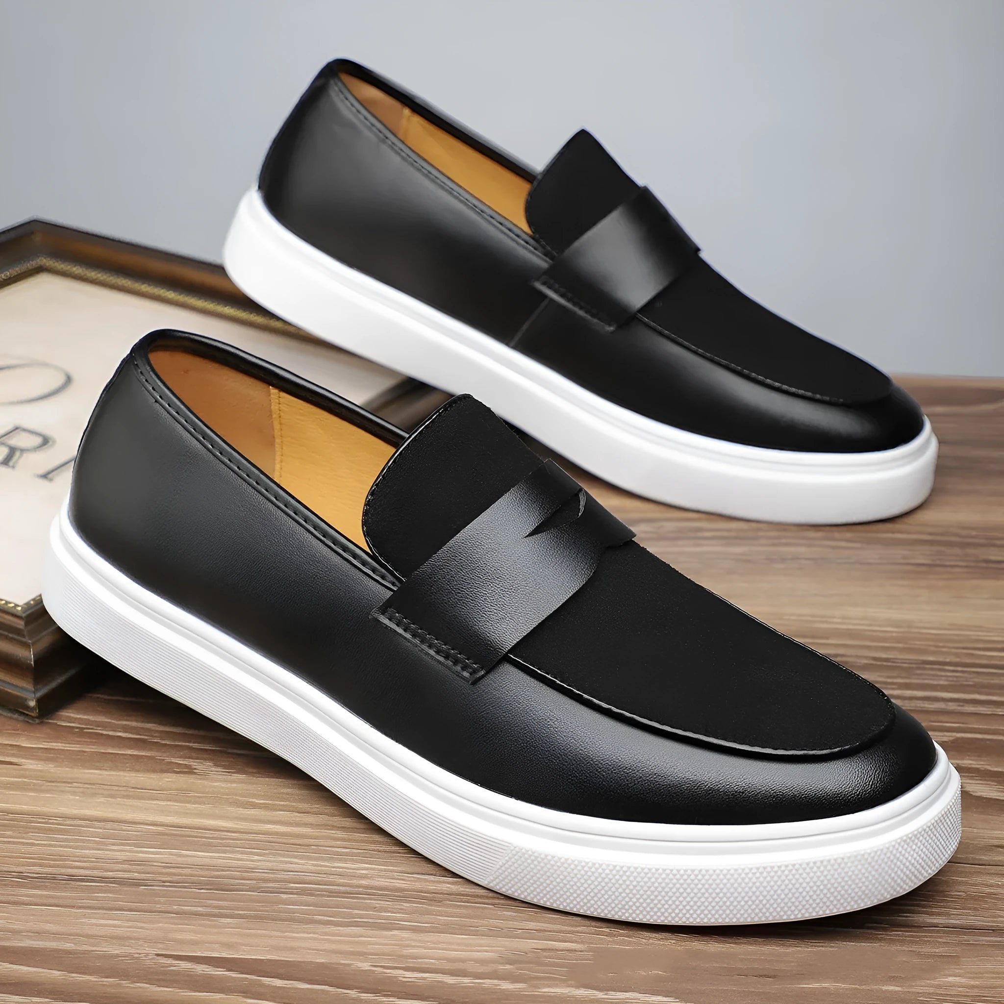Black men's slip-on Gommino casual shoes with tassel detail on round toe.
