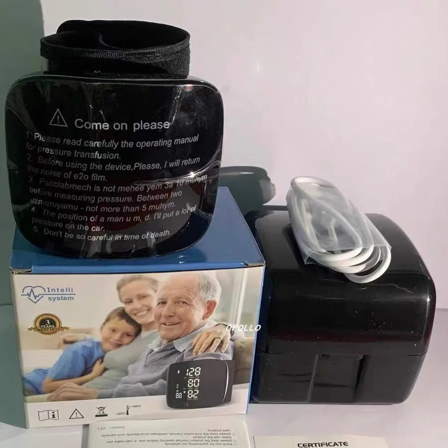 Black wrist blood pressure monitor with USB charging port on a table