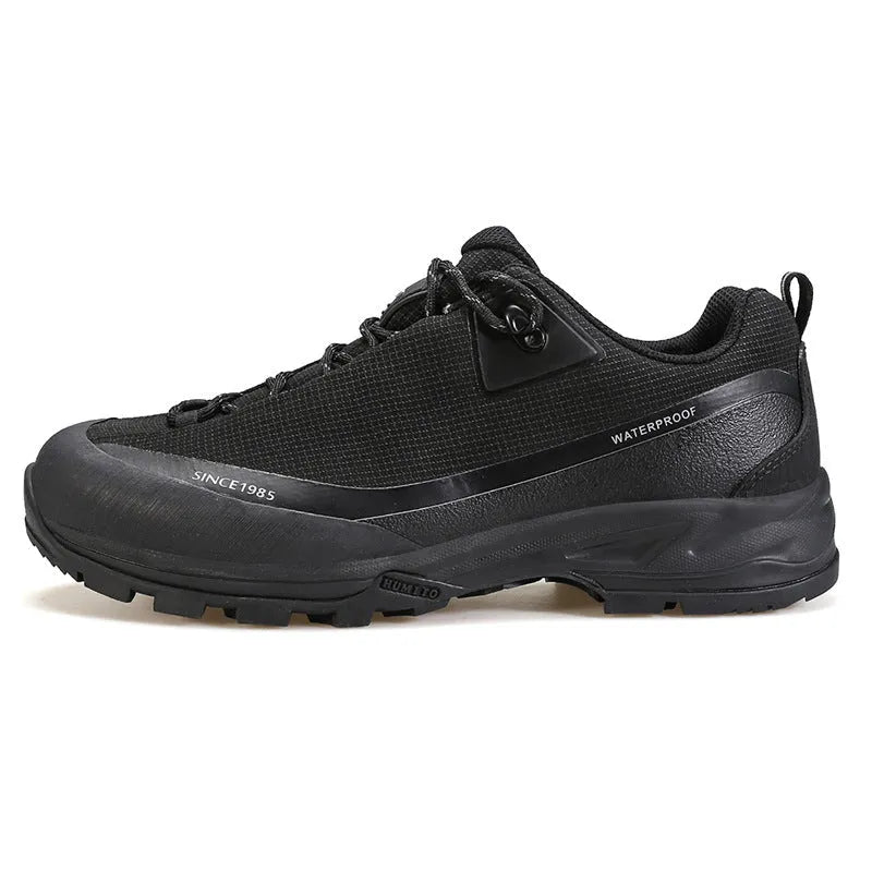 Men's low-top mountain climbing hiking boots in black with lace-up front and non-slip rubber sole.