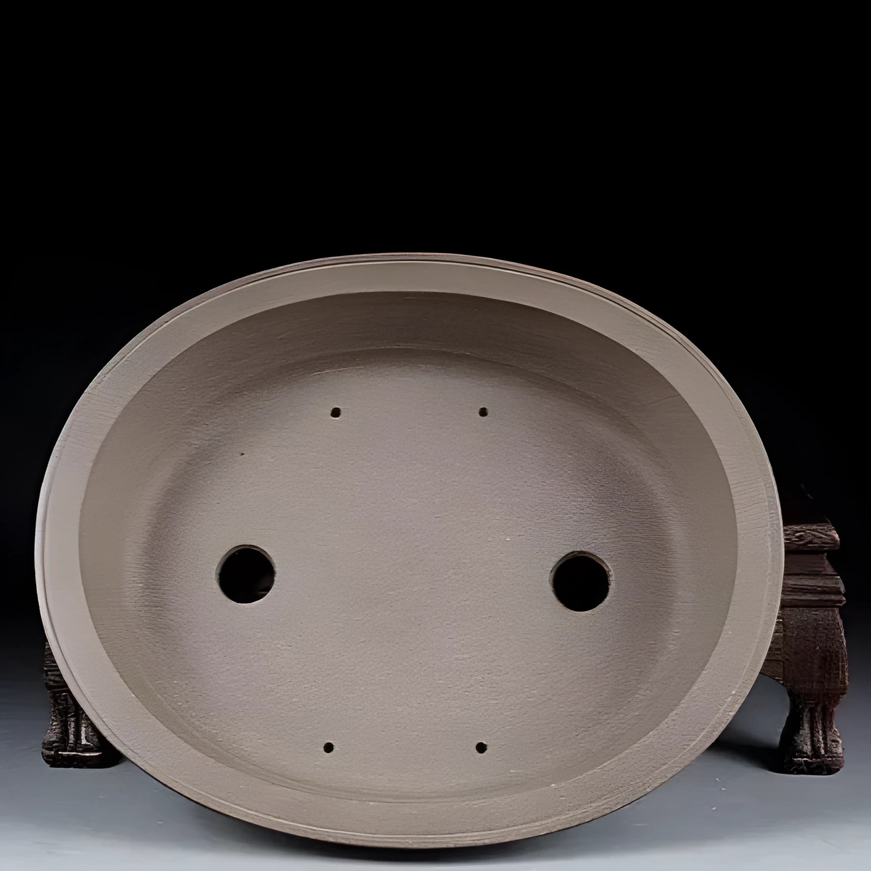 Handmade oval purple sand ceramic bonsai flower pot measuring 25 by 21 by 6.3 centimetres.