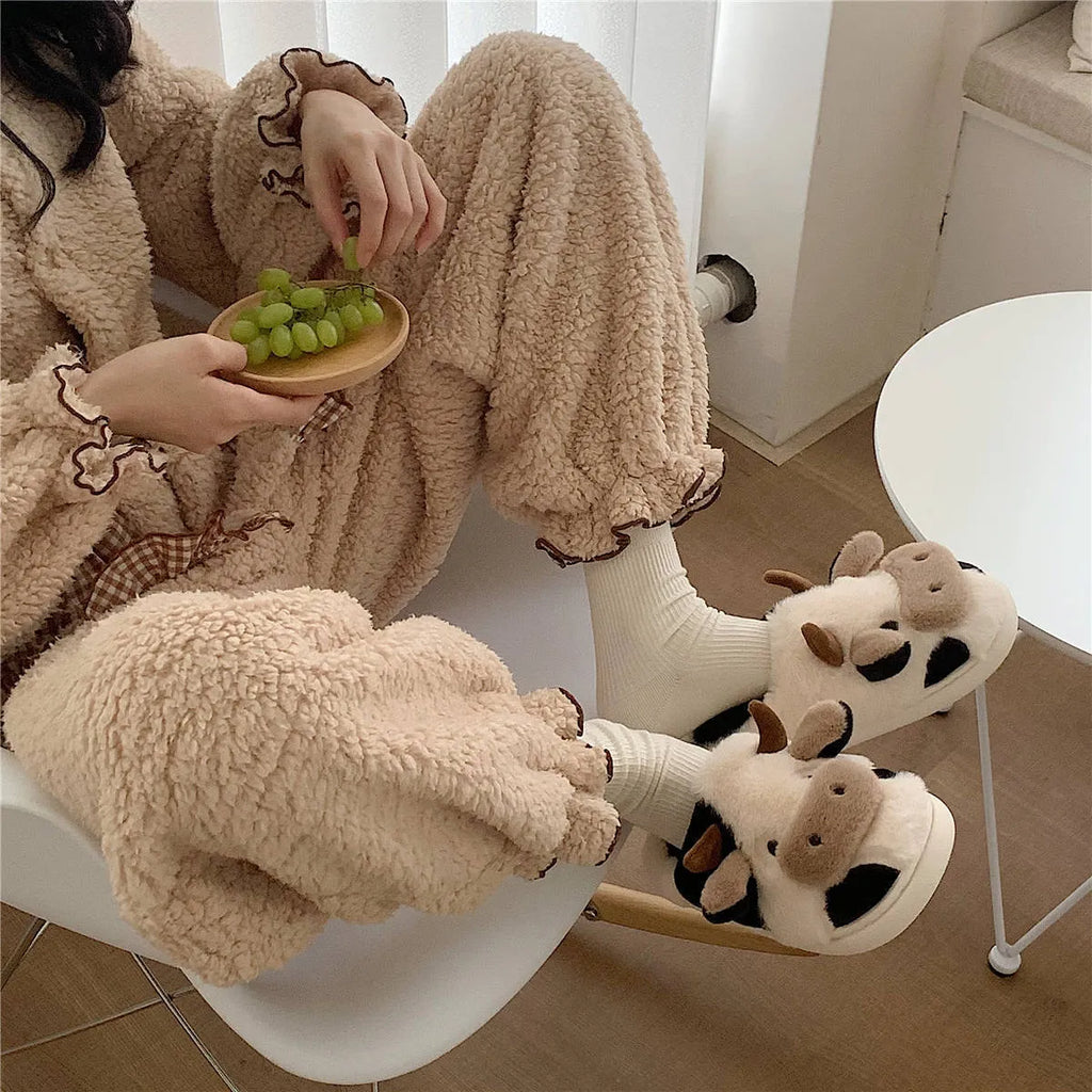 White cow plush slippers with cartoon milk cow pattern and non-slip textured sole