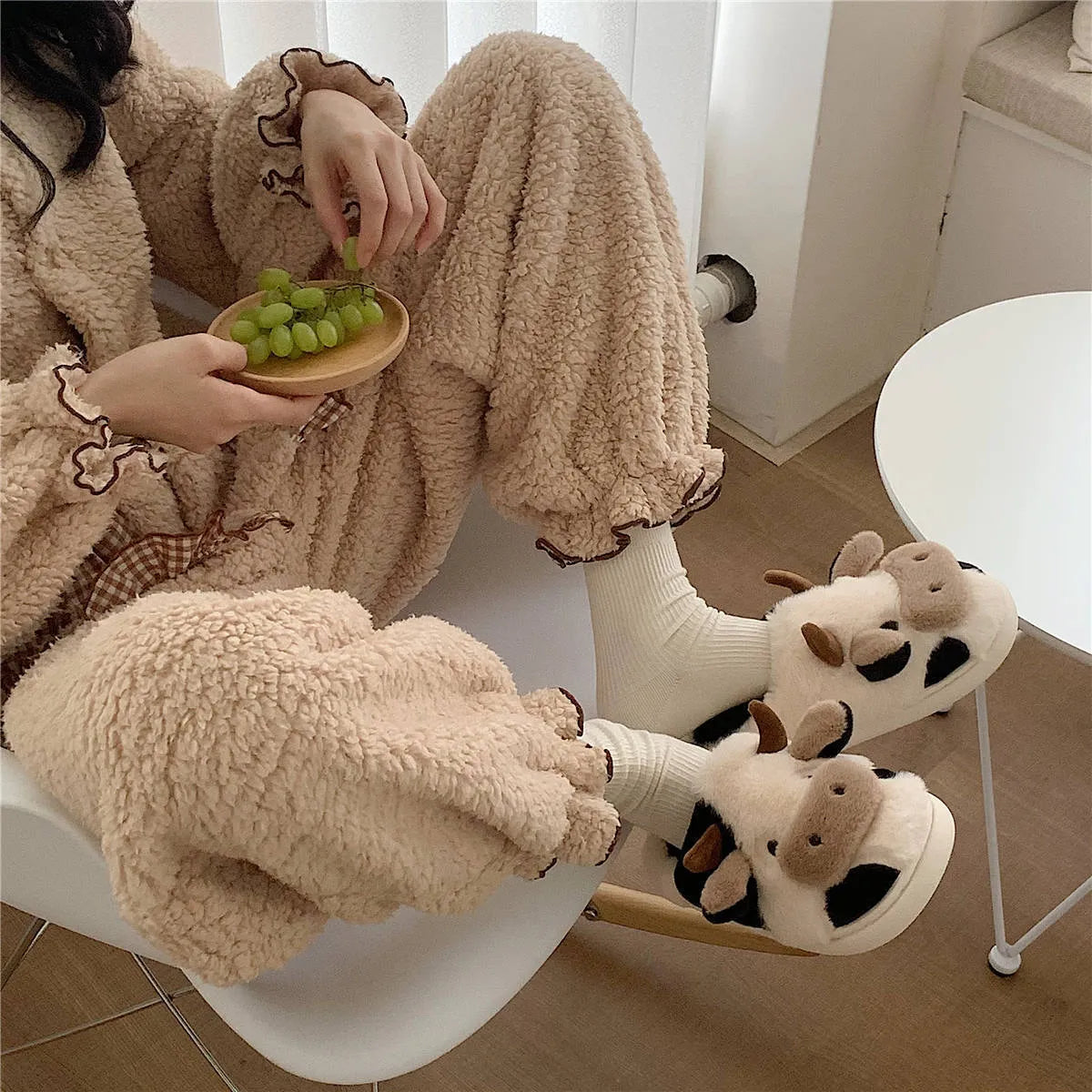 White cow plush slippers with cartoon milk cow pattern and non-slip textured sole