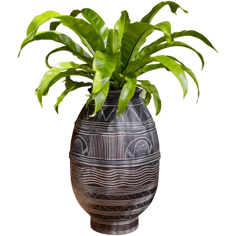 Medium cement flower pot with African ancient tank ethnic design and drainage hole.