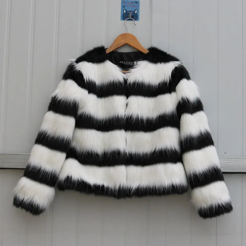 Womens black and white striped faux fur leather jacket with long sleeves on a model.