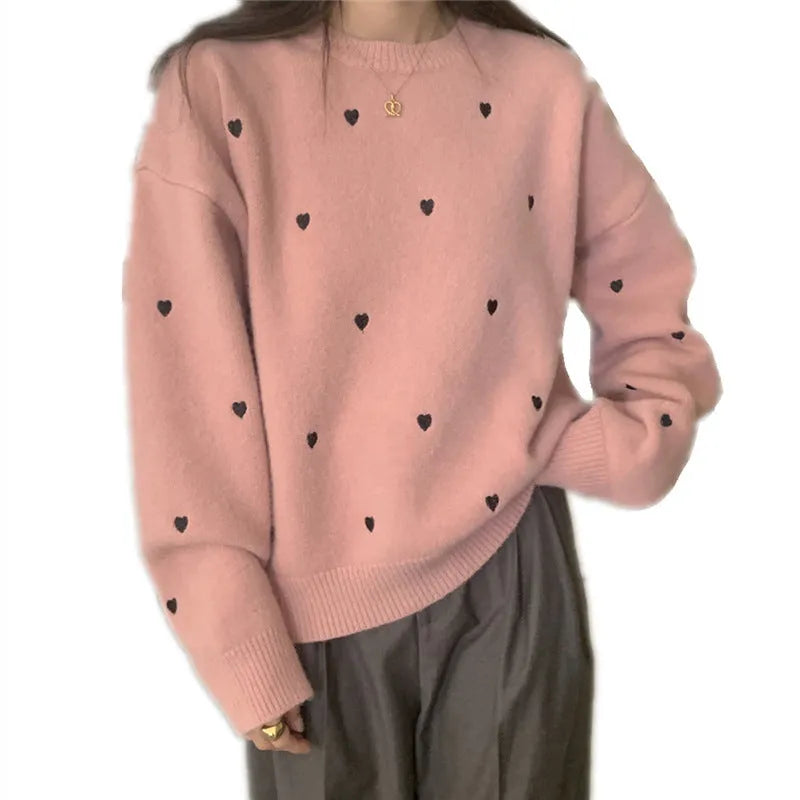 Women's loose grey acrylic pullover sweater with embroidery on the chest and long sleeves.