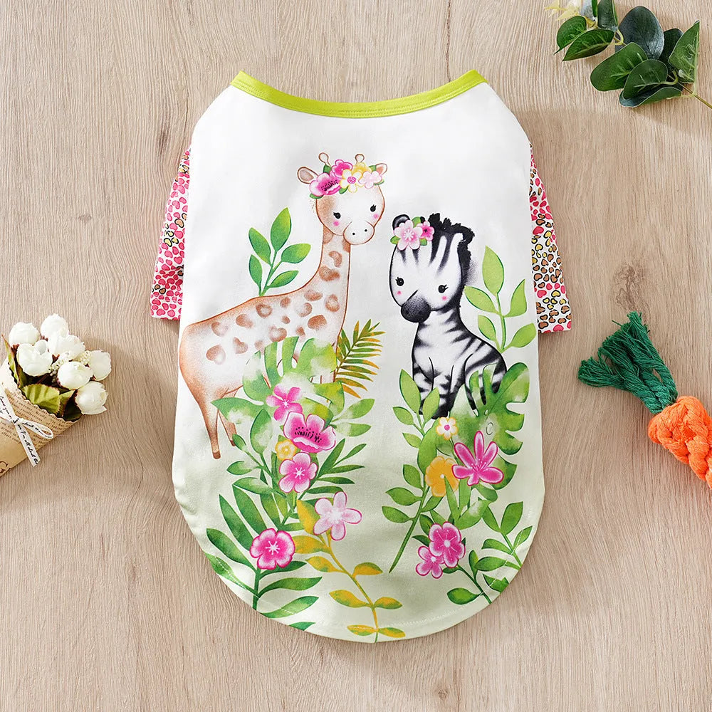 A small dog wearing a colourful full-print polyester casual T-shirt.