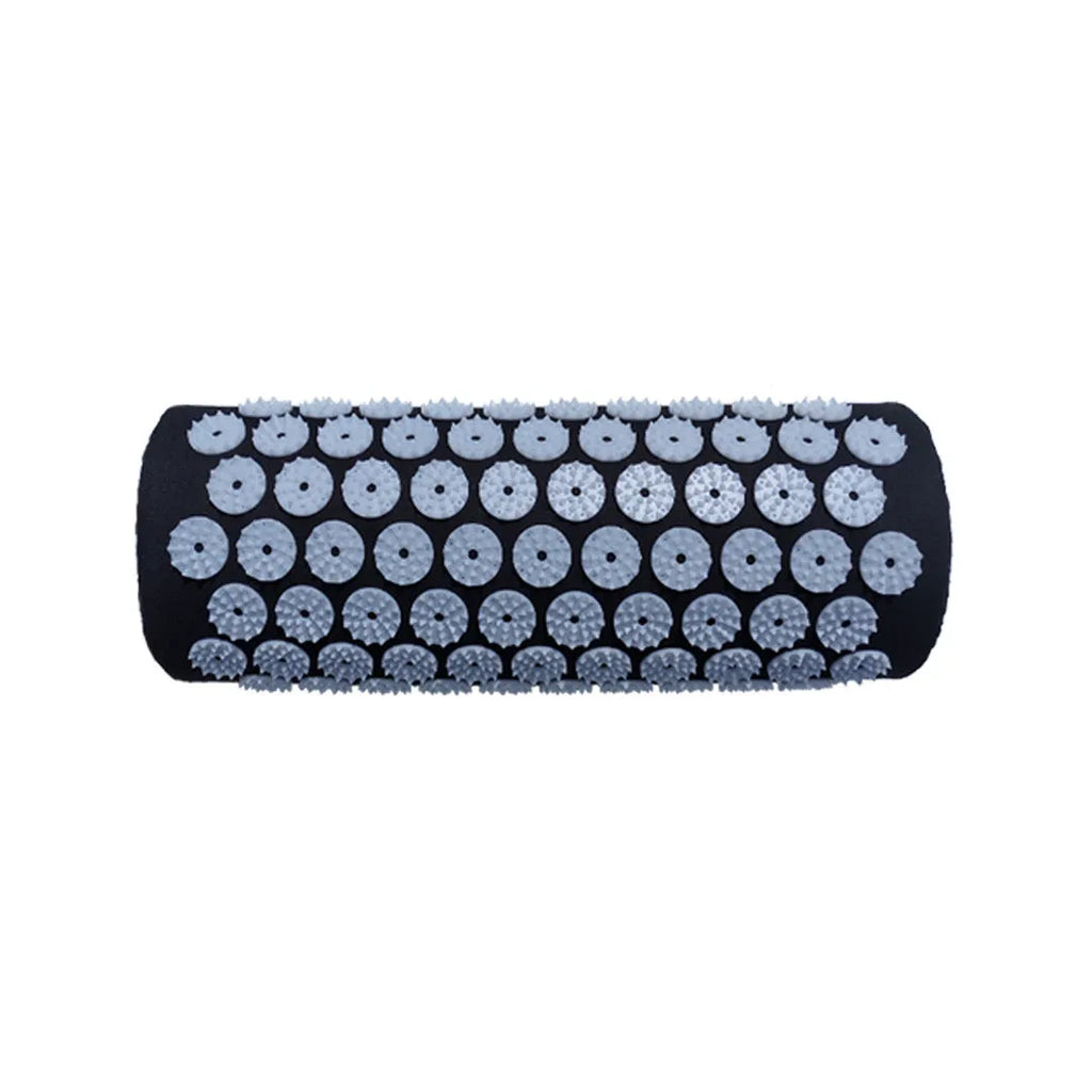 Black and blue acupuncture massage mat with cushion and headrest on floor