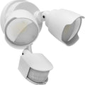 White outdoor LED security flood light with motion sensor mounted on a wall bracket