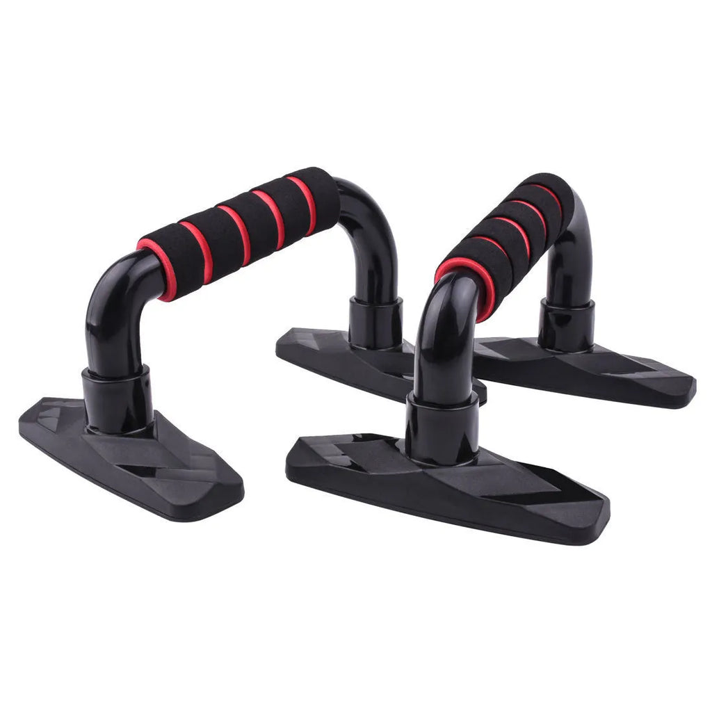 Two black I-shaped push up bars with grey PP sponge handles on a floor.