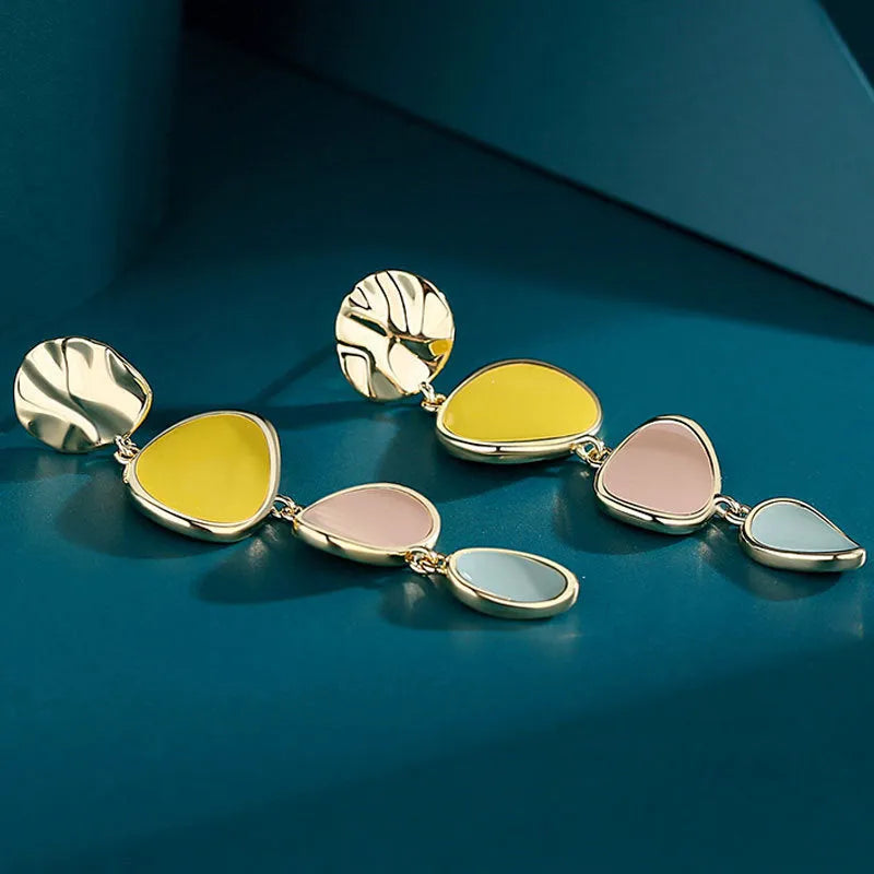 A pair of simple vintage wafer earrings in Morandi colours with a sterling silver needle post.
