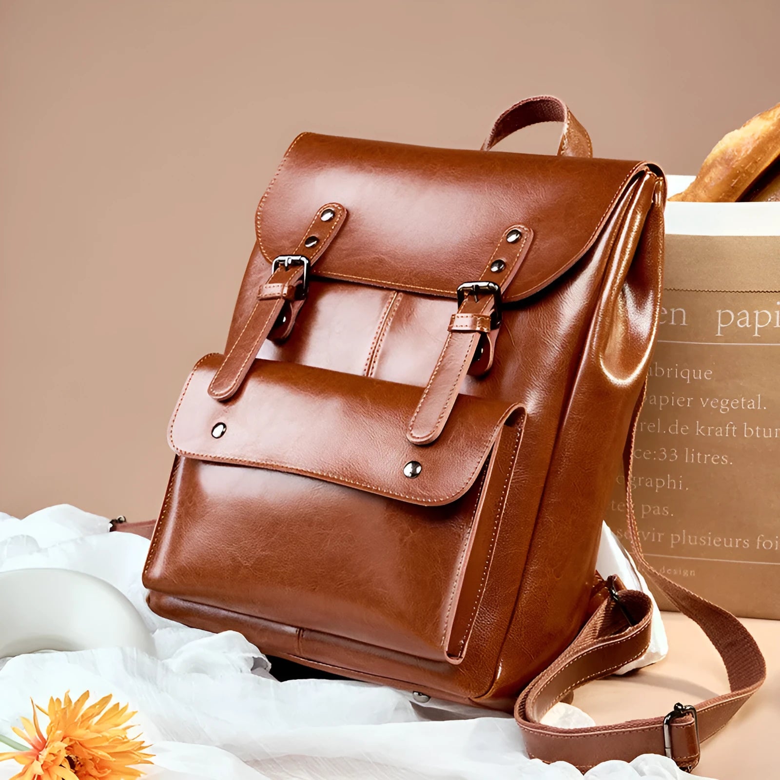 Black two-layer cowhide leather computer backpack for women with internal lining.