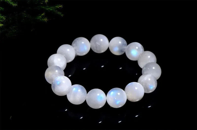 Natural blue moonlight round bead moonstone bracelet on a white background, showing polished geometric beads.