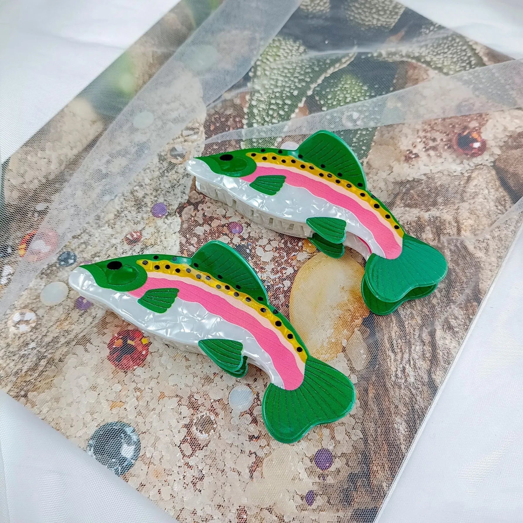 Dark green PVC hair clip featuring a printed rainbow trout and carp design.