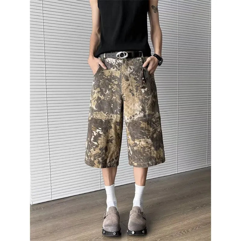 Yellow jeans with a snake camouflage pattern, shown in a cropped length.