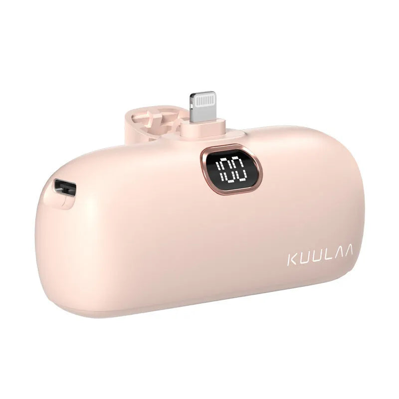 Compact cylindrical alloy power bank with built-in charging cable and LCD digital display.