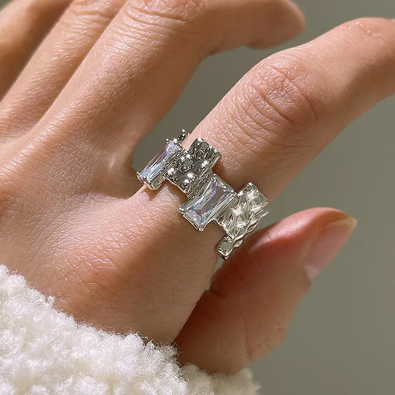 Silver cross ring with geometric design and open gemstone setting