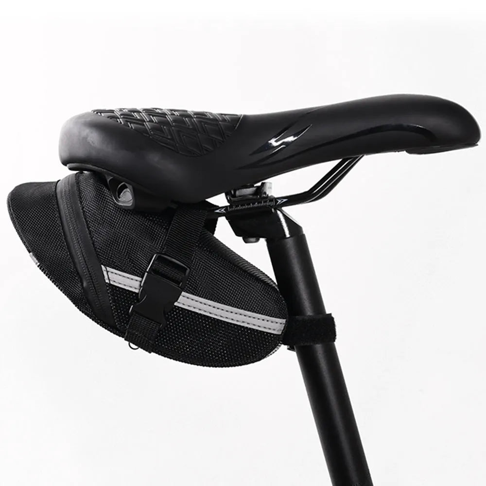 Black quick release bicycle saddle bag mounted under a bike seat