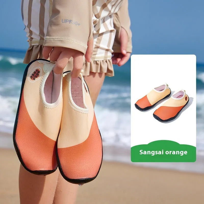 Children's anti-slip beach shoes in assorted colours with rubber soles and polyester fibre uppers.