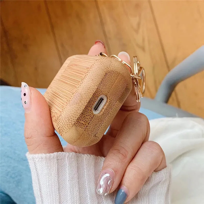 Wood grain clamshell earphone cover for AirPods 1 or 2 in carbonized wood colour, made from wood or bamboo.