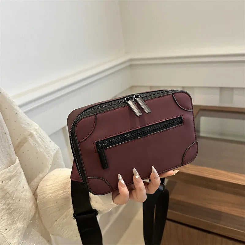 Women's small square crossbody bag in PU leather, horizontal shape, shown in one of five colours with visible sewing lines.