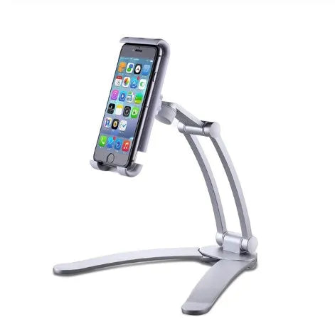 Silver aluminium desktop tablet stand holding a tablet, showing 360-degree rotation and dual adjustable clip design.
