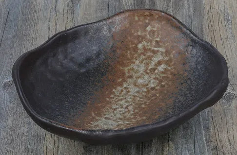 Japanese-style irregular coarse pottery sashimi bowl with floral decoration on glaze