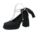 Beige women's Mary Jane shoes with chunky heel, round toe, and pearl- detail ankle strap on a white background.