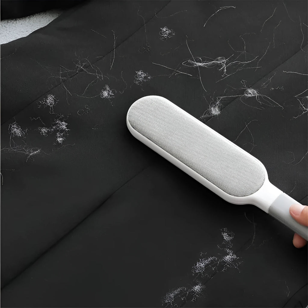 Electrostatic hair removal brush with polyester yarn bristles, two sizes and colour options, on a fabric surface