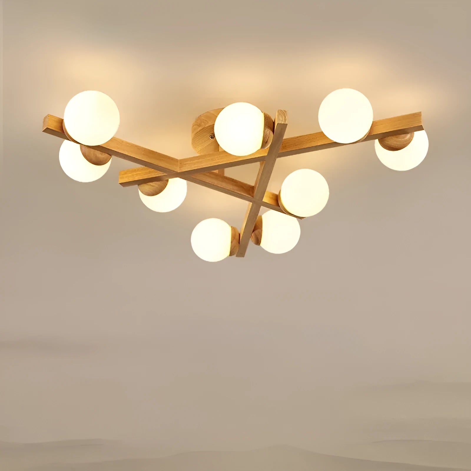 Modern black and copper three-headed pendant ceiling light with adjustable arms hanging over a wooden table