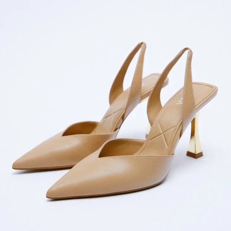 Women's patent leather pointed high heels in apricot colour showing shallow mouth design.