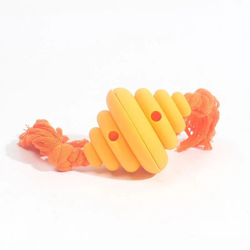 Green and yellow spiral dog ball with attached rope for tug-of-war and treat dispensing