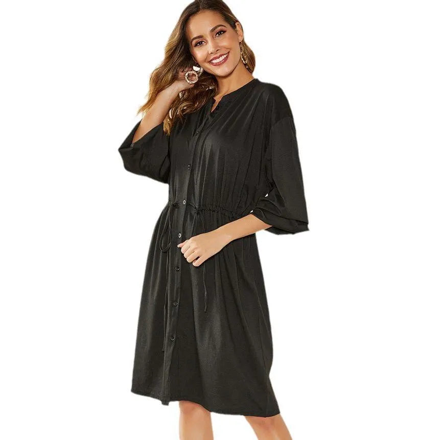 Black mid-length A-line dress with long sleeves, elasticated waist, and a detachable red belt.