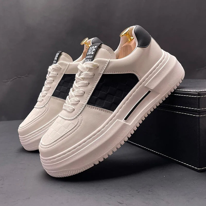A pair of white, black, and green casual sports shoes with cloth uppers and rubber foam soles.