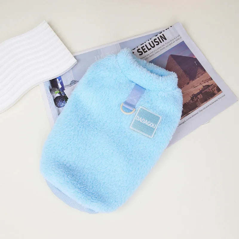 A soft coral fleece dog jacket shown in blue, available in sizes S to XXL.
