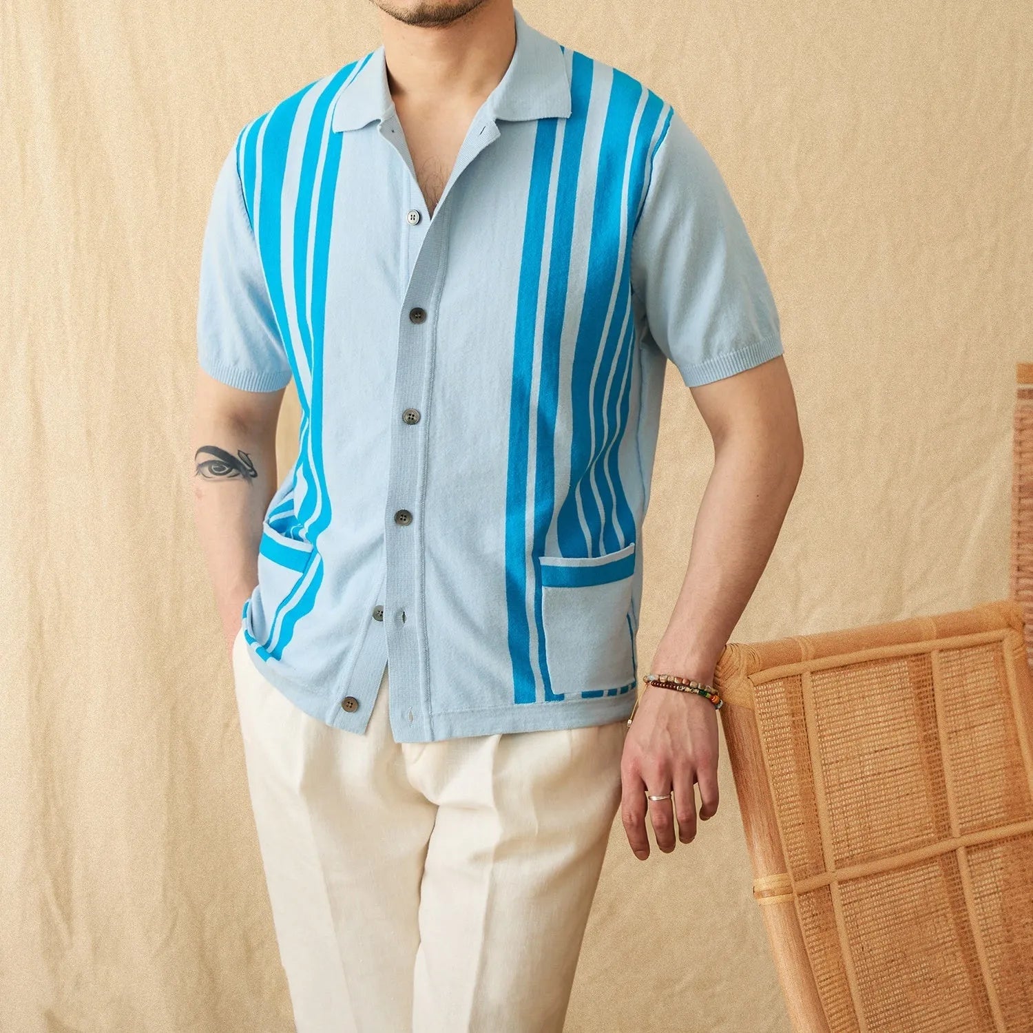 Light blue striped cotton polo cardigan with short sleeves and a lapel collar on a hanger.