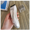 Children's barber scissors set with comb, limit combs, oil bottle, and brush in white