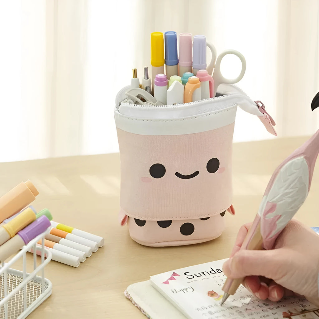 Canvas retractable pencil case with heart smiley face design in blue velvet milk tea colour, showing retractable pen holder