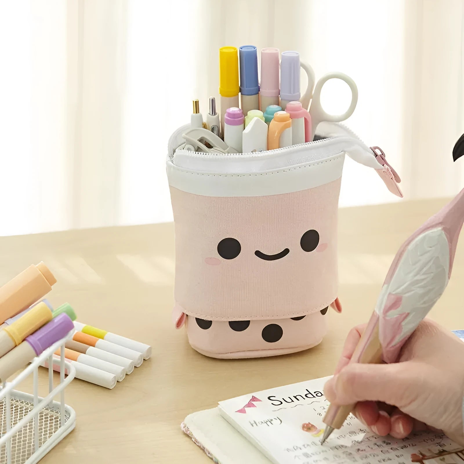 Canvas retractable pencil case with heart smiley face design in blue velvet milk tea colour, showing retractable pen holder
