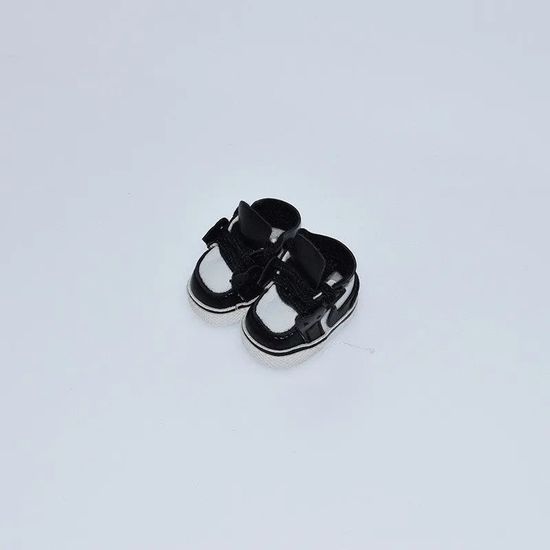 A pair of 17 cm high black doll shoes made from PU leather, shown as a keychain accessory.