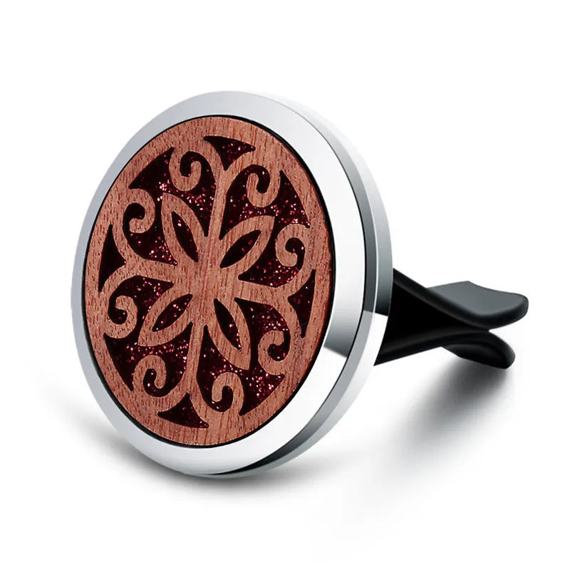Round car vent aromatherapy clip in alloy wood construction showing hollow centre for incense