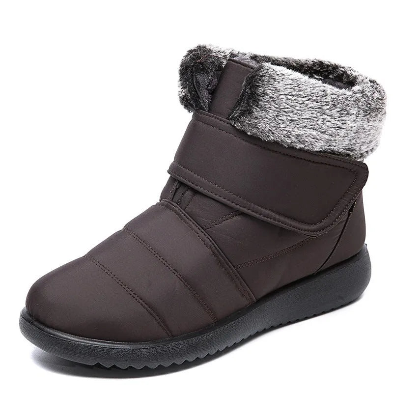 Women's winter snow boots with plush lining, suede upper, velcro strap, flat heel, and anti-skid rubber sole in black.