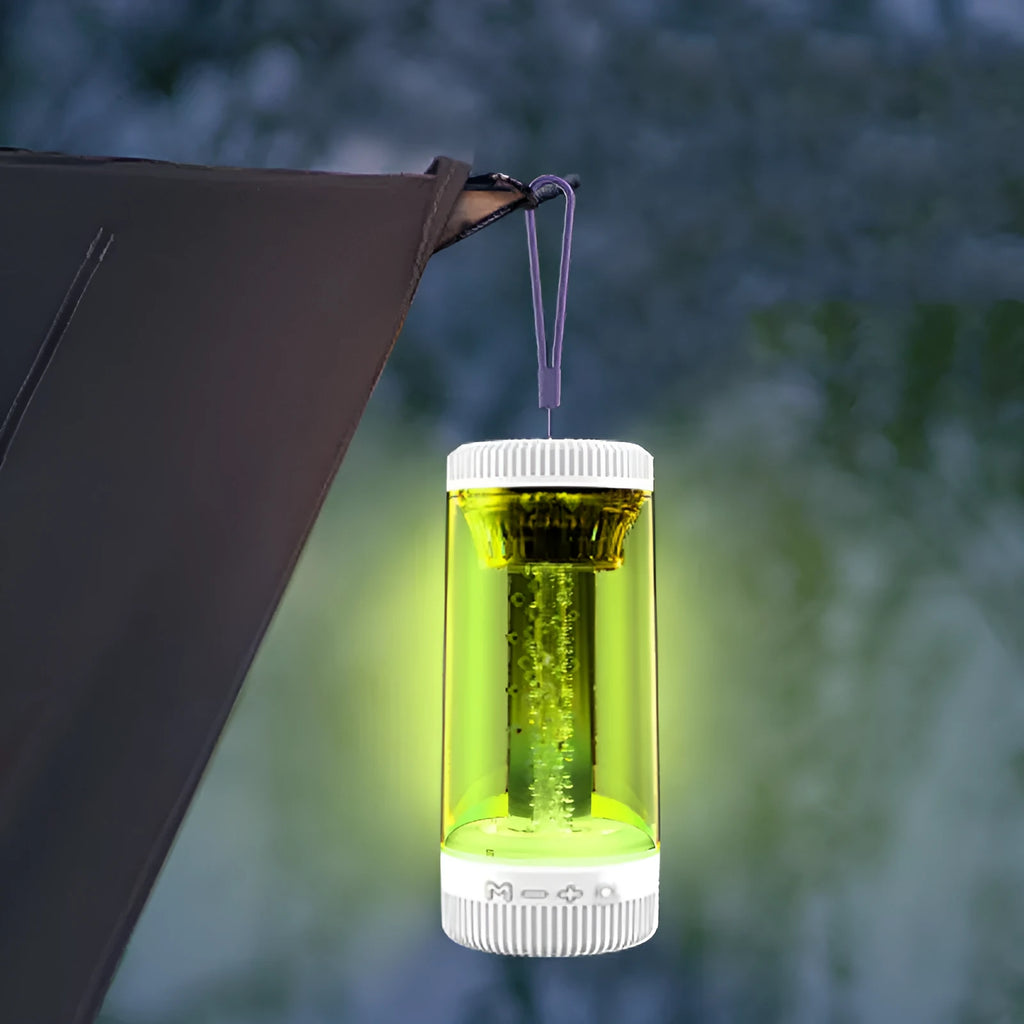 Black outdoor portable camping light Bluetooth speaker with LED colourful light on a natural background