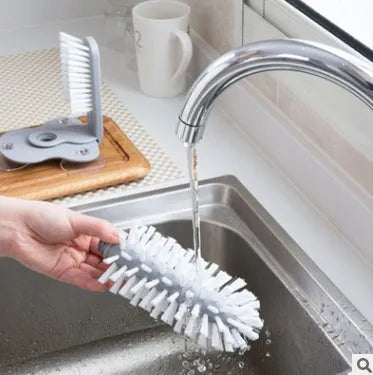 Grey rotating cup brush with dual heads and suction cups for wall mounting