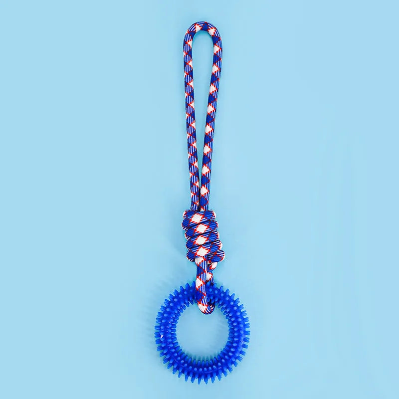 Blue, red, and rose red braided rope dog toy with a large central knot.