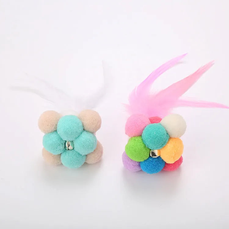 Cat toy feather bouncy ball with colourful pink feathers and blue white feathers for interactive play