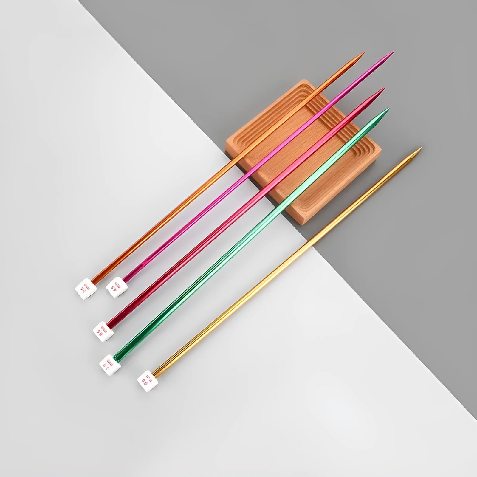 Set of aluminium crochet hooks with extended handles and protective caps, showing multiple sizes from 2.0mm to 10.0mm