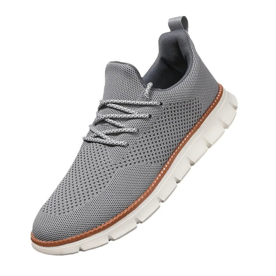 Men's grey and black mesh fabric casual sneakers with a round toe and low heel on a plain background.