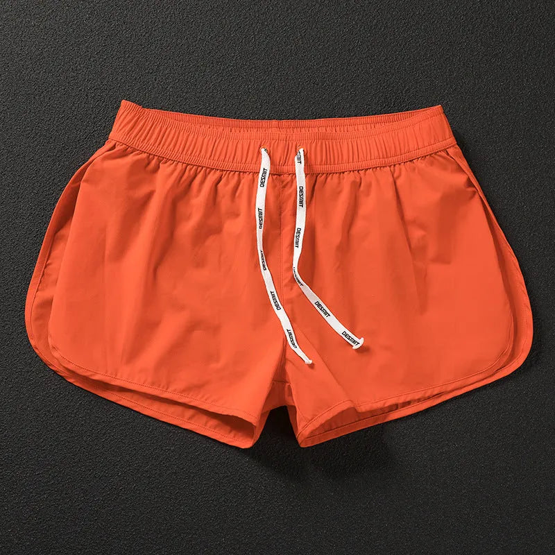 Men's loose beach shorts in polyester available in orange, green, and black colours