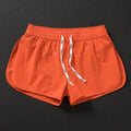 Men's loose beach shorts in polyester available in orange, green, and black colours